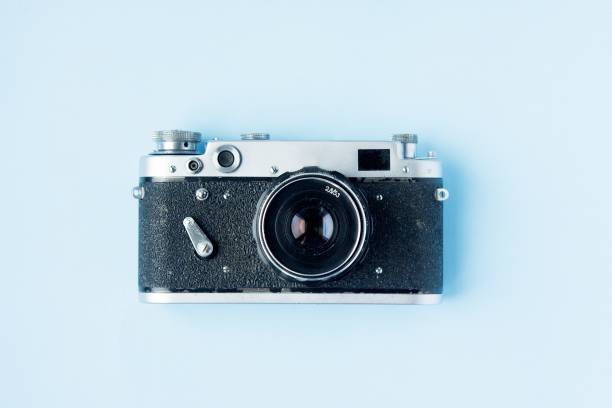 istock Retro film photo camera on blue 1190400103