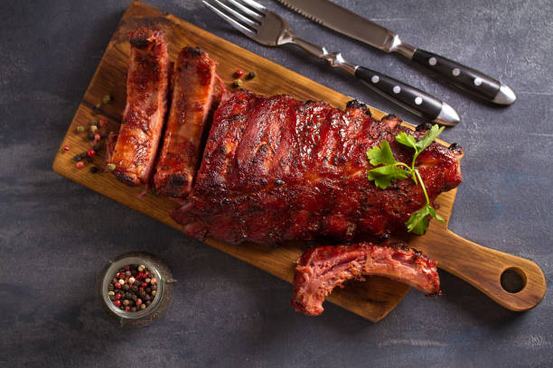 Pork loin ribs served on chopping board Pork loin ribs served on chopping board. View from above, top plate rack stock pictures, royalty-free photos & images