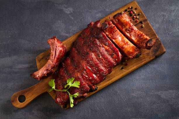 Pork loin ribs served on chopping board Pork loin ribs served on chopping board. View from above, top pork stock pictures, royalty-free photos & images