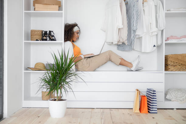 istock Joyful young woman using notebook at home 1190402805