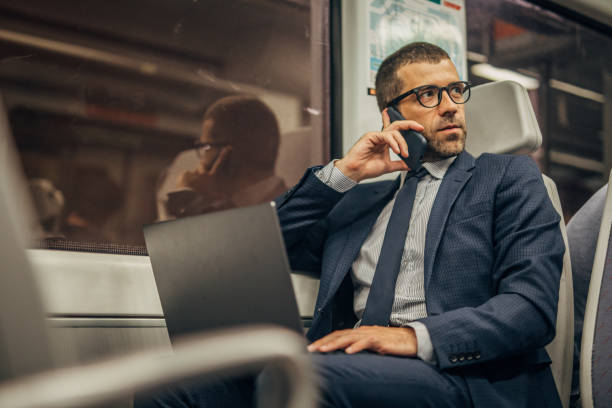 istock Handsome businessman talking on mobile in subway train 1190403283