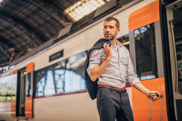 istock Handsome businessman going traveling by train 1190404170