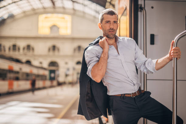 istock Handsome gentleman going traveling by train 1190404729