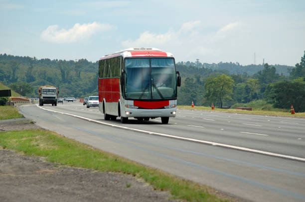 red and white old tourism bus and traffic on major highway