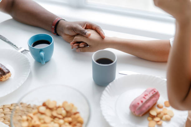 istock Young couple in love holding hands in cafe 1190408643