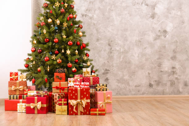 istock Decorated Christmas tree in soft yellow lights with bokeh effect background. Lofty apartment with traditional new year holiday decoration, intimate lighting. Close up, copy space. 1190409223
