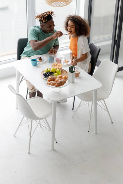 istock Joyful man feeding his girlfriend in cafe 1190409229