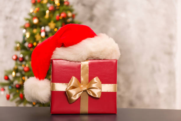istock Decorated Christmas tree in soft yellow lights with bokeh effect background. Lofty apartment with traditional new year holiday decoration, intimate lighting. Close up, copy space. 1190409236