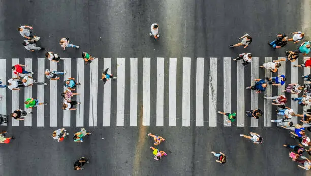 Photo of Aerial. Pedestrians on a zebra crosswalk. Top view.