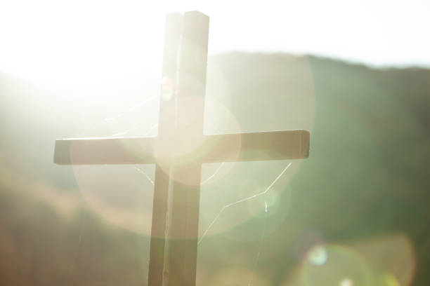 istock cross in nature at the sunset 1190410597