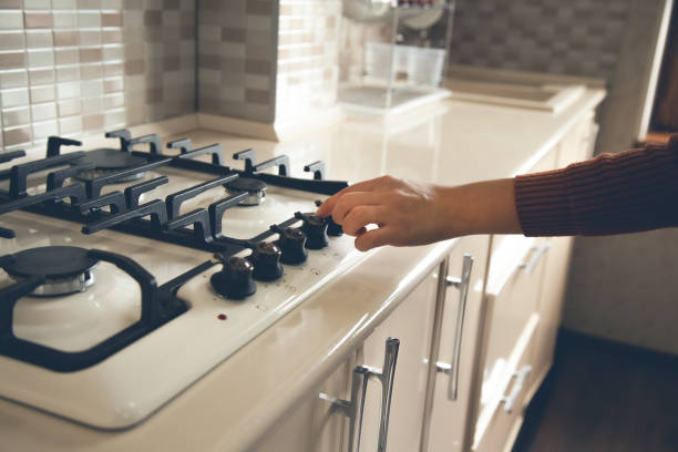 istock woman hand holding gas in kitchen 1190410690