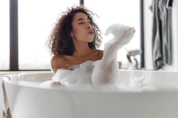 istock Charming Afro American lady relaxing in bathtub 1190411156