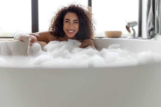 istock Cheerful Afro American lady taking bath at home 1190411232