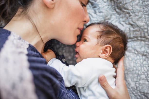 istock Mother cuddling her baby boy 1190411288