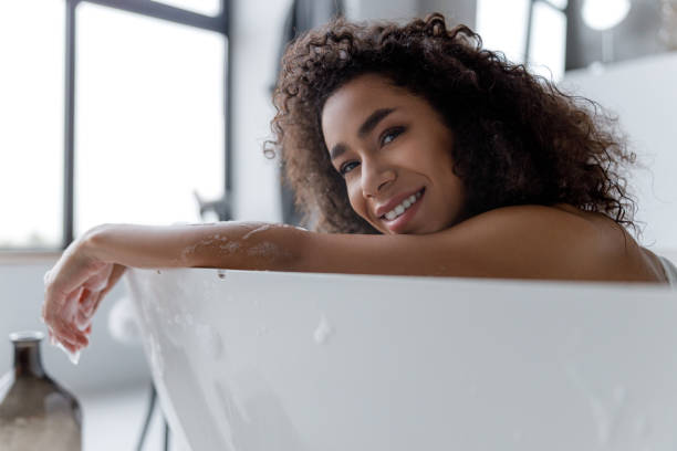 istock Joyful Afro American woman relaxing in bath 1190411355