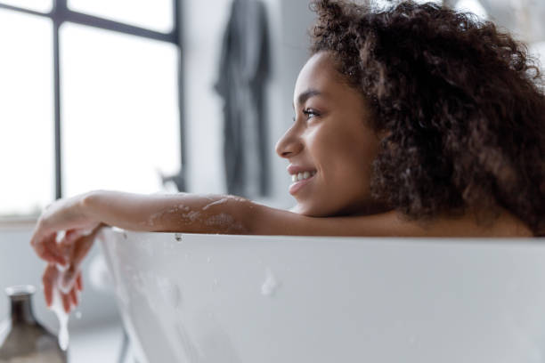 istock Charming Afro American woman relaxing in bath 1190411371