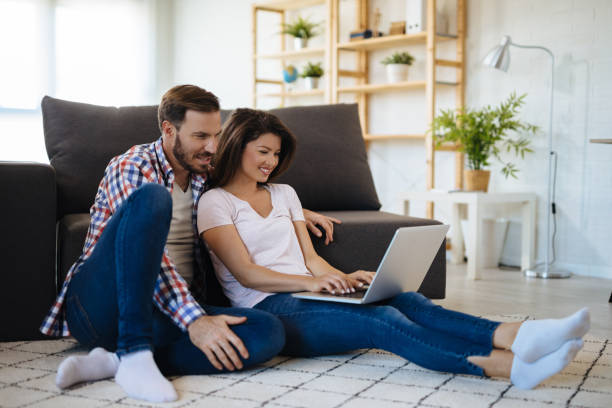 istock Affectionate couple resting at home and using laptop 1190411429