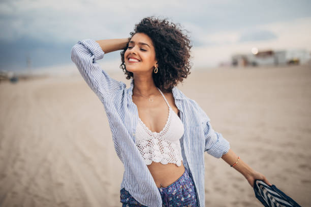 istock Stunning woman standing on the beach 1190412435