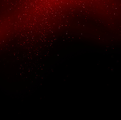 Red sparks over black background with copy space