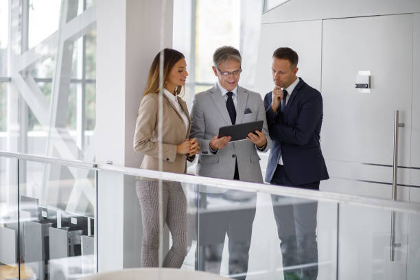 istock Group of mixed aged business people collaborating over digital tablet 1190412677
