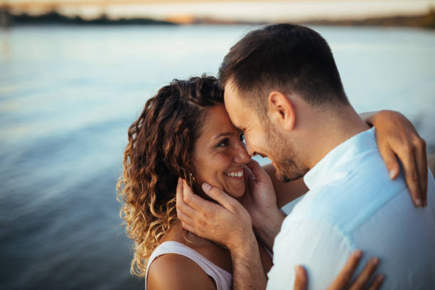 istock Couple in love by the river 1190413204