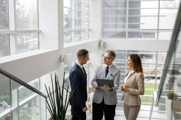 istock Business people collaborating over digital tablet on the staircase 1190413532