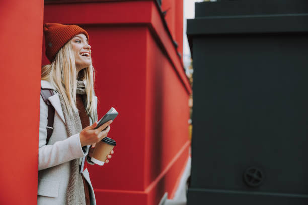 istock Female student with hot drink laughing outdoors 1190414965