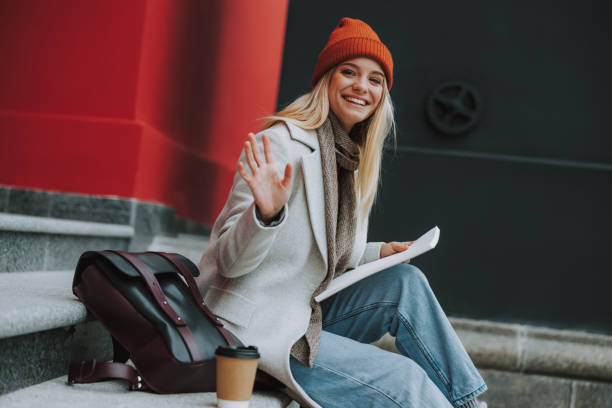 istock Smiling pretty girl waving hello with hand 1190415028