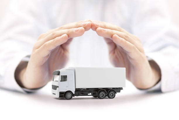 istock Cargo delivery truck protected by hands 1190415045