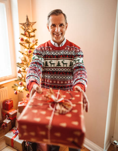 istock mature adult posing with a christmas gift 1190415285