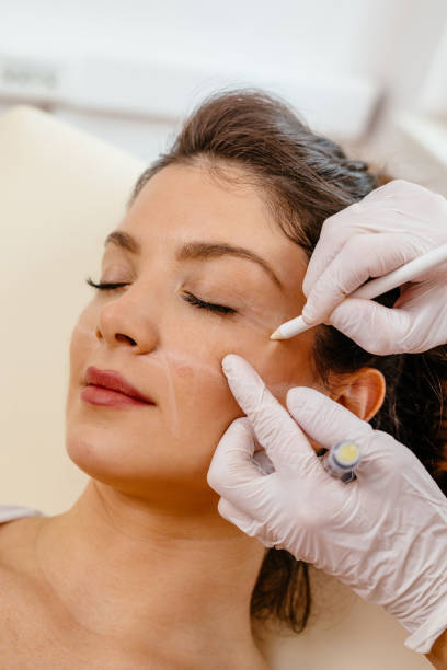 istock Beautiful woman's face is being prepared for plastic surgery 1190415329