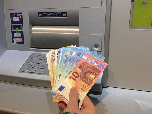 istock Getting money from the ATM 1190415445
