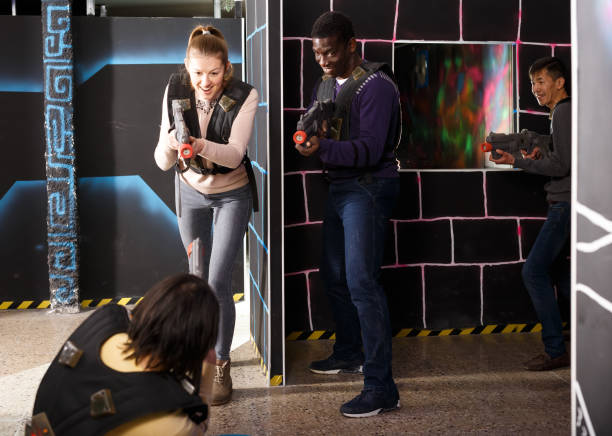 istock Cheerful international team aiming laser guns 1190418004