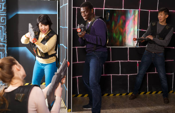istock Happy international team aiming laser guns 1190418061