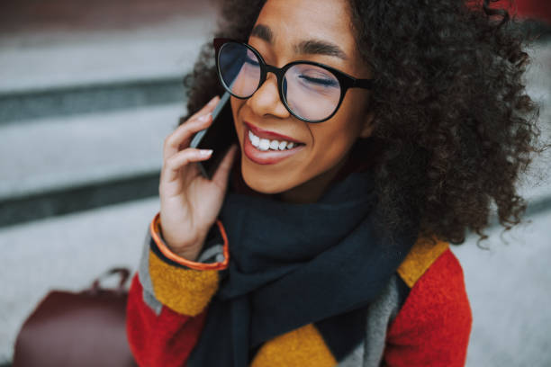 istock Afro American girl talking on smartphone and smiling nice 1190418973