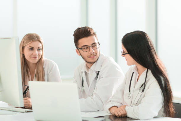 istock group of medical experts discussing online information. 1190423195