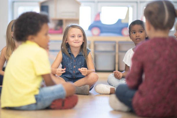 istock Kindergarten Class Snapping Their Fingers and Singing During Circle Time stock photo 1190424826