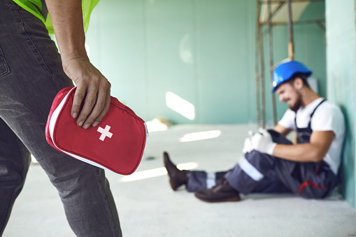 Construction worker accident with a construction worker. First aid for injury at work.