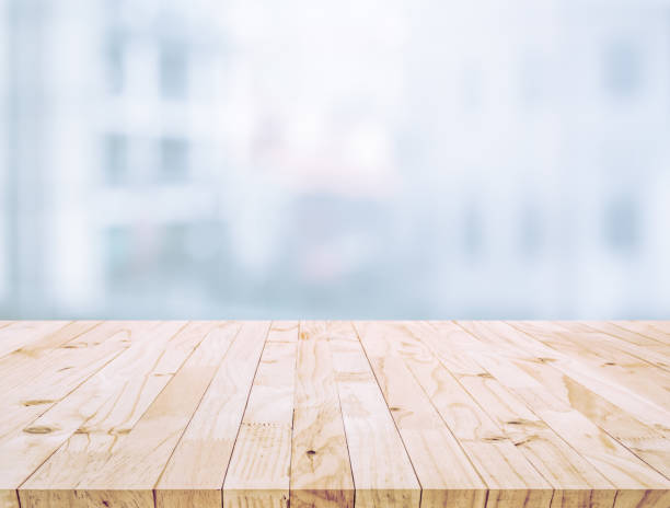 istock Selective focus of wood table top on white wall glass (big window) background 1190425984