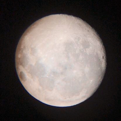 Stock photo showing a full moon shining against a black, night time, starless sky.