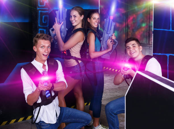 istock Young people posing with laser pistols 1190430031