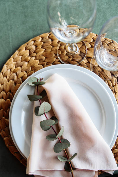 istock Festive table. Eucalyptus branch on a pink fabric napkin 1190430230
