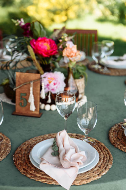 istock Festive table setting. Plates decorated with eucalyptus branches and elegant napkins in nude colors. 1190430240