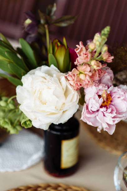istock Chic peonies on a table in a brown glass bottle 1190430242