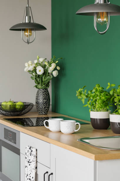 istock Herbs, flowers, apples, and coffee mugs on kitchen counter 1190430383
