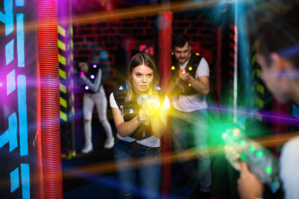 istock Female laser tag player in bright beams 1190430759