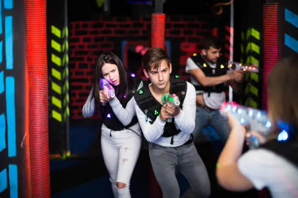 Photo of Guy and girl during laser tag game