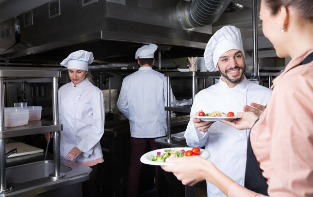 istock Chef with team preparing food 1190430799