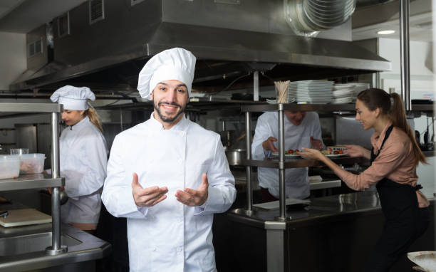 istock Chef in kitchen with busy staff 1190430822