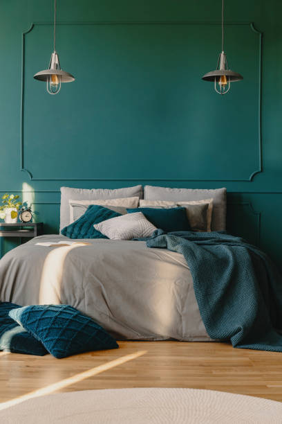istock Copy space on empty green wall of elegant bedroom interior 1190431770